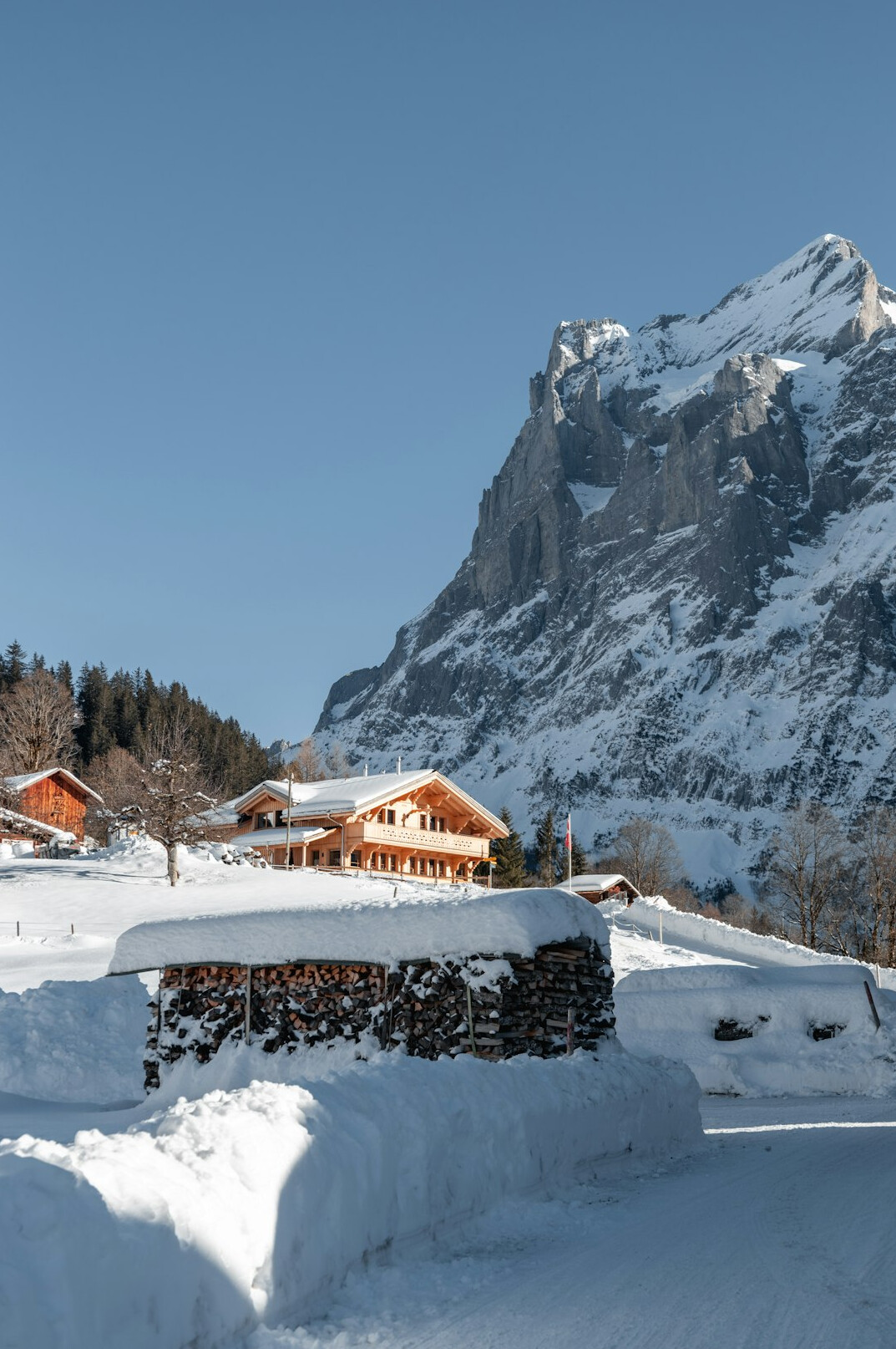 Wooden alpine chalets covered in snow in Switzerland