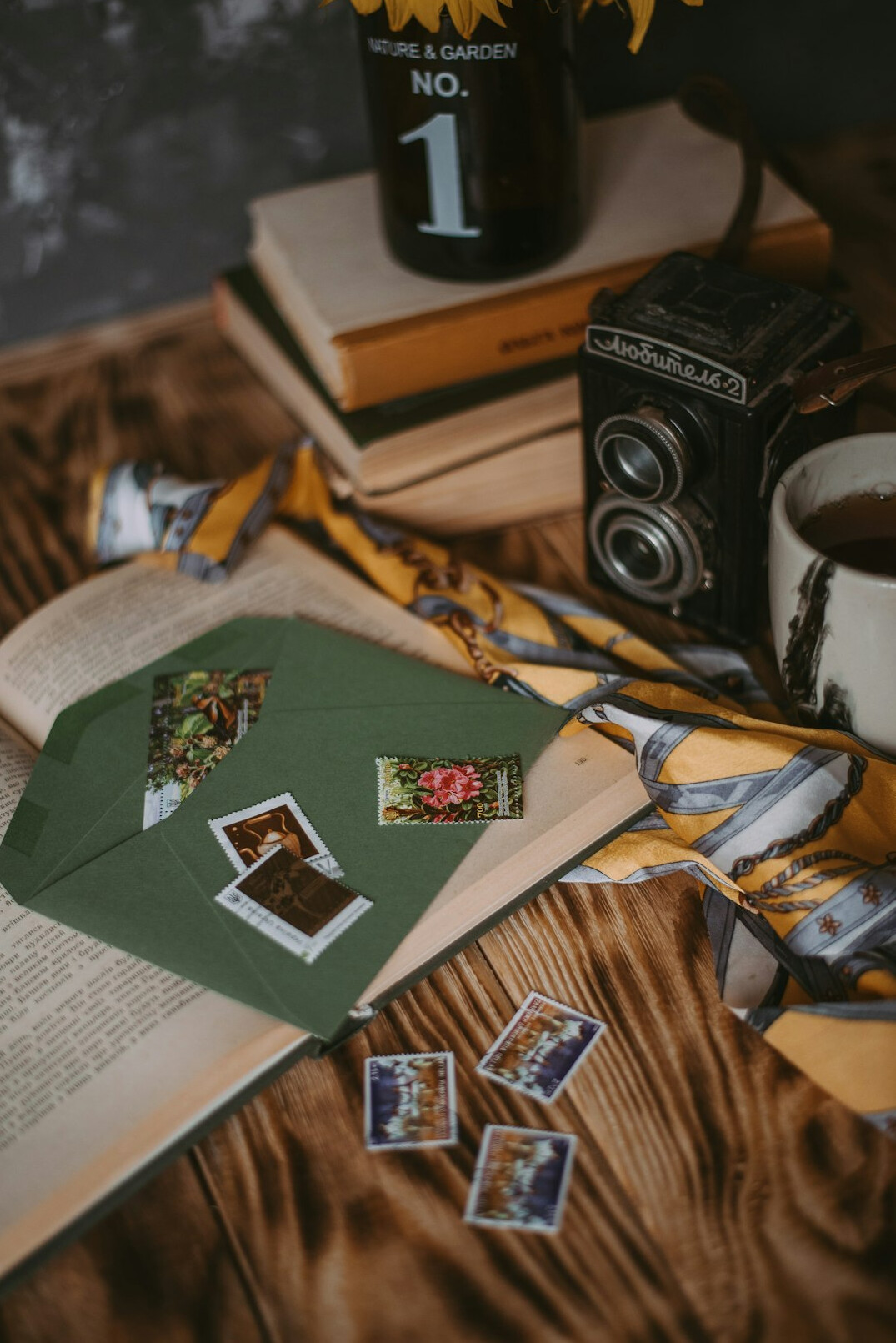 Stack of vintage magazines and photographs on a table